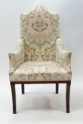 An Edwardian inlaid mahogany armchair with front sabre legs