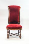 A Victorian mahogany nursing chair, the turned and block legs joined by an H-stretcher,