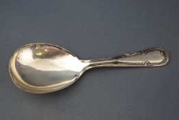 A silver caddy spoon, with ribbon and flowerhead handle, Sheffield 1944,