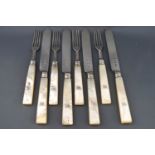 A set of eight Victorian silver bladed and mother of pearl handled fruit knives and forks,
