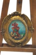 A print of a flower fairy on oval ceramic panel within a gilt frame,