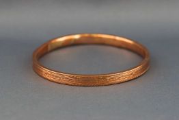 A hallmarked 9ct rose gold large hollow slave bangle. (Dented) 10.