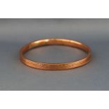 A hallmarked 9ct rose gold large hollow slave bangle. (Dented) 10.