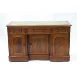 A Victorian mahogany kneehole desk, the top inset with green leather writing surface,