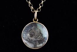 A 9ct gold belcher chain with circular shell South African pendant of a man. 7.