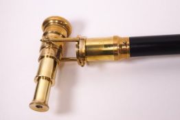 An ebonised walking stick with brass 'telescope' handle, the end stamped 'Ross,