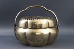 A Chinese white metal hand warmer, of lobed form,