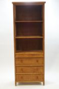 A modern teak bookcase with three shelves over three drawers, 197.