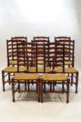 A set of eight George II style oak and ash ladder back chairs,