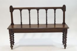 A Victorian oak hall bench with barley twist back and legs,