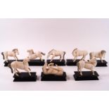 A set of eight early 20th century Chinese ivory Mu Wang horses on wooden stands,