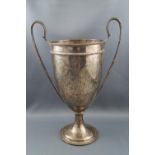 A silver two handled trophy cup, with two beaded handles on a flared foot, engraved "A.A.M.