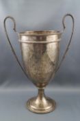 A silver two handled trophy cup, with two beaded handles on a flared foot, engraved "A.A.M.