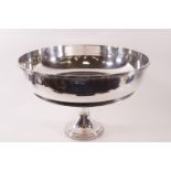A large modern silver plated bowl with reeded and cross detail to outer rim,