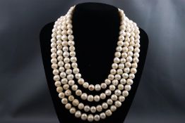 A large four strand cultured freshwater pearl necklace with base metal paste stone clasp.