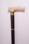 A walking stick with simulated ivory handle,