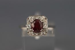 A white metal ruby and diamond cluster ring. Ruby approx 1.47ct. Diamond approx 0.
