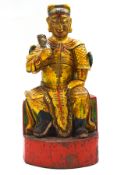 A Chinese carved painted and gilded figure of a temple guardian,