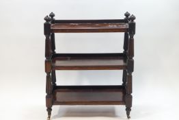 A late Victorian mahogany three tier buffet on turned supports and ceramic casters,
