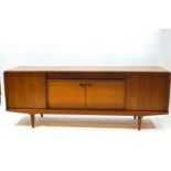 A Danish teak sideboard by Clausen & Son, with sliding doors enclosing shelves,