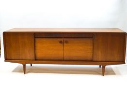 A Danish teak sideboard by Clausen & Son, with sliding doors enclosing shelves,