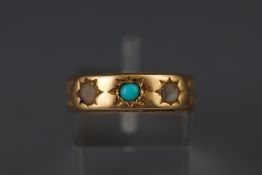 A yellow metal three stone ring set with turquoise and seed pearls.