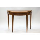 A George III mahogany demi-lune card table with boxwood stringing and square tapering legs, 73.