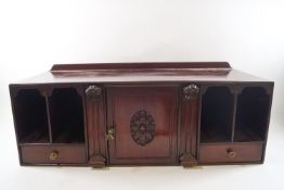 A 19th century mahogany table top stationery cabinet with central cubby space,