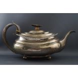A George IV silver tea pot, of boat form with flowerhead finial, on four ball feet,