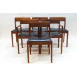 A Danish draw leaf dining table and six chairs with black leatherette seats,