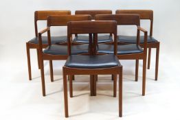 A Danish draw leaf dining table and six chairs with black leatherette seats,