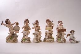 A set of Capodimonte porcelain figures of putli playing musical instruments, each on scroll bases,