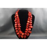 Two large abstract shaped natural coral necklaces with silver clasps.