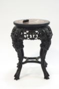 A Chinese carved hardwood table with inset marble top,