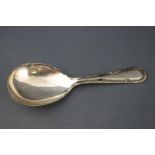 A silver caddy spoon, with ribbon and flower head handle, Sheffield 1944,