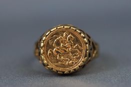 A yellow metal coin set ring. Coin stamped 750 and to reverse dated as 1915 with 'Good luck'.