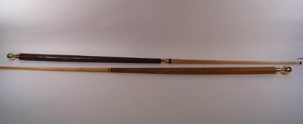 A near pair of carved walking sticks, converting to pool cues,