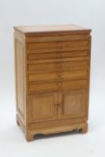 A teak side cabinet with five drawers and cupboard below,