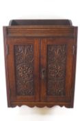 An Edwardian carved oak smoker's cabinet, 45cm high x 32cm wide x 16.