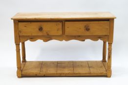 A small pine two drawer sideboard with under-tier, 76cm high x 122cm wide x 45.