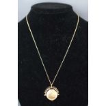 A spinning round locket pendant with fine link chain, gold plated. 5.