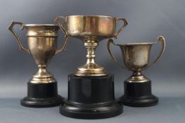 Three silver two handled trophy cups, 8cm and smaller, Birmingham 1931 and two Birmingham 1934,