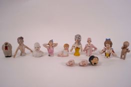 A collection of early 20th century porcelain half dolls and bisque doll heads