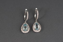 A pair of white metal aquamarine and 0.50ct diamond cluster drop earrings with hook and clip clasp.