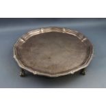 A silver salver with beaded rim, on three ball and claw feet, 20cm diameter, London 1923,