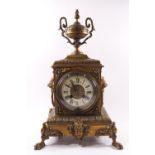 A Victorian brass clock garniture,
