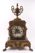 A Victorian brass clock garniture,