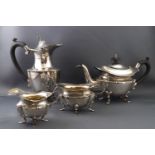 A silver four piece tete a tete tea set, by E S Barnsley & Co,