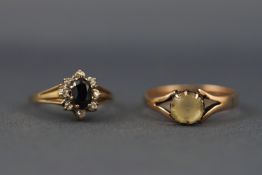 A selection of two hallmarked 9ct gold dress rings to include a sapphire and diamond cluster ,