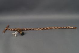 A rose gold Albert chain with two seal fobs attached, T bar and swivel clasp.